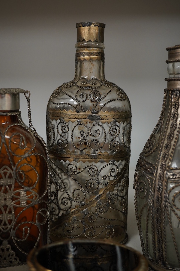 A collection of continental glass and wire worked bottles and flasks and a gilt metal onyx trinket box, tallest 19.5cm
